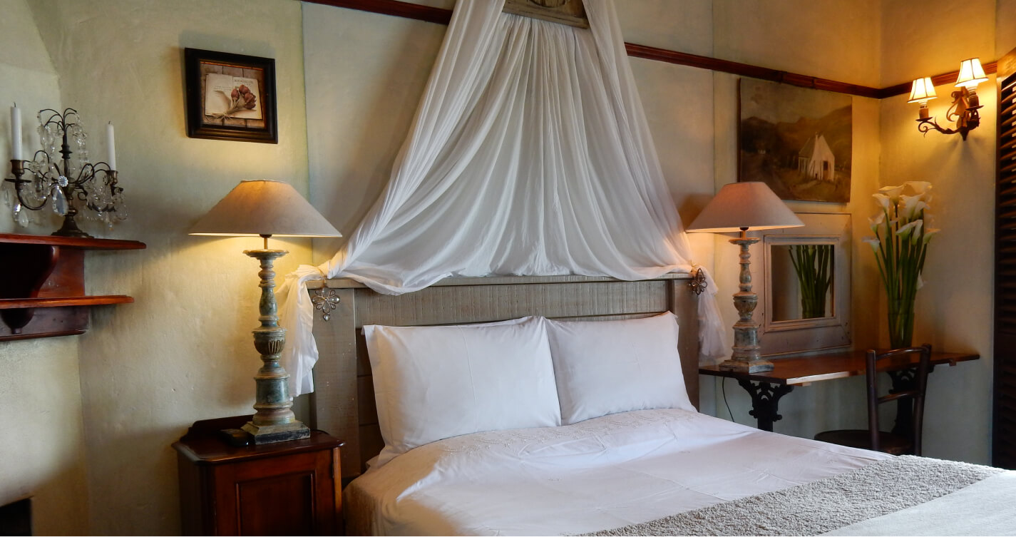 The romantic double bed in Lovers Nest Cottage at TwoAngels in Knysna.