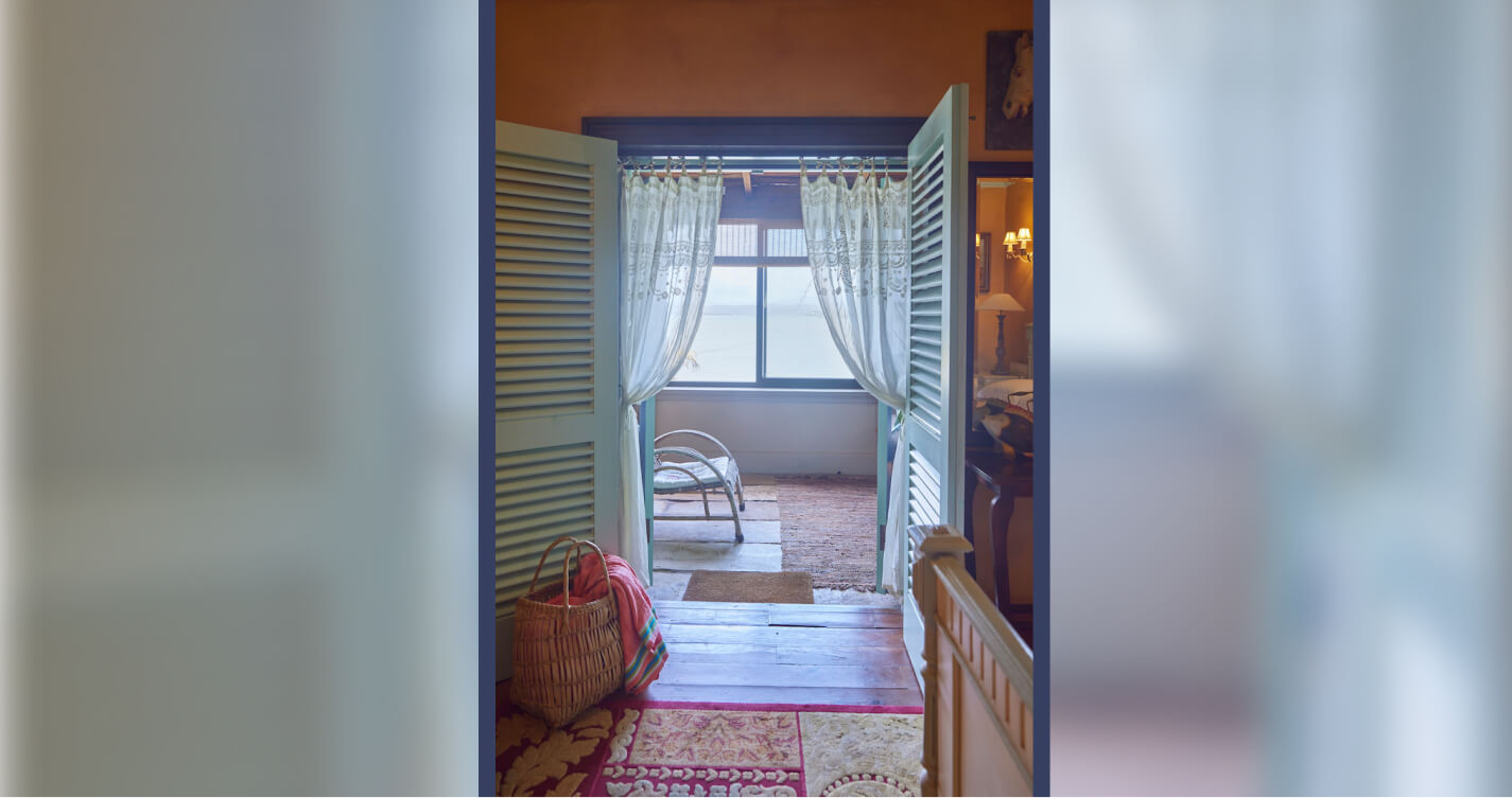 A view looking out the entrance of Owl's Nest bedroom and onto the sea.