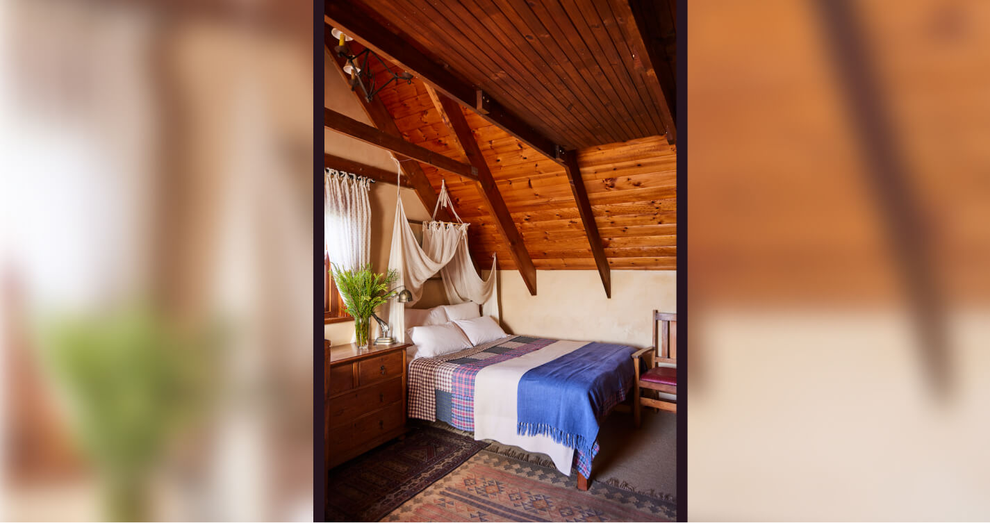 The double bed in The Cavalry bedroom. The room is bright and natural light from the windows.